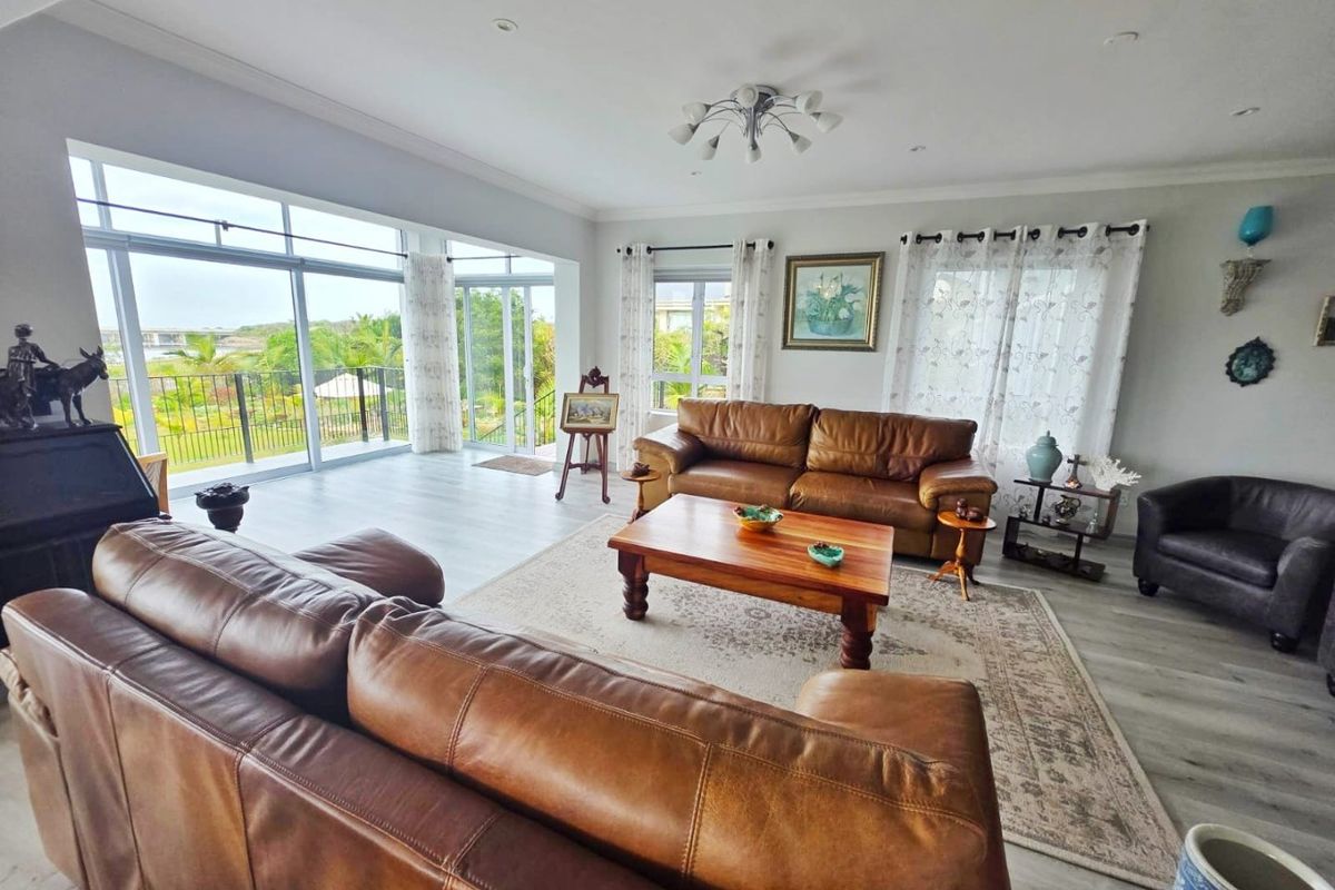 Spacious living room featuring large sliding glass doors that provide abundant natural light and access to the outdoor area.