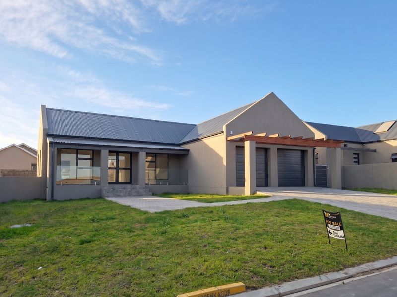 Modern single-story residential home featuring a double garage, timber pergola, glass balustrade entrance, and a paved driveway.