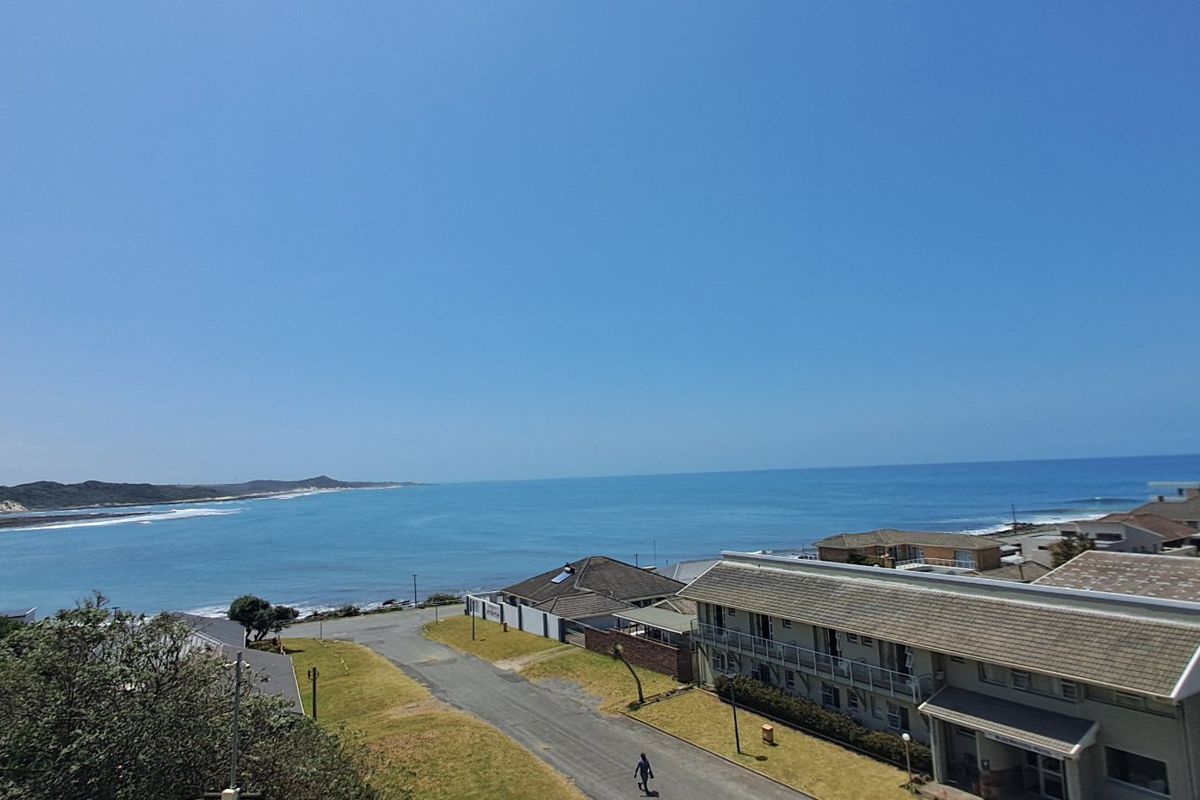 Elevated coastal view overlooking the ocean, surrounding residential properties, and local street infrastructure.