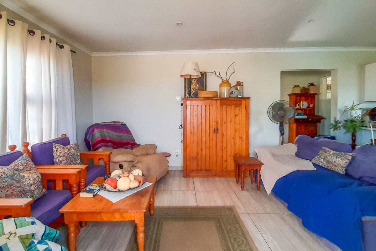 A spacious living room featuring neutral wall tones and tiled flooring, offering a comfortable and functional layout for relaxation.