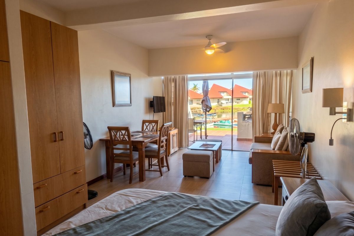 A bedroom featuring built-in cabinetry, tiled flooring, and a sliding glass door providing access to an outdoor patio area.