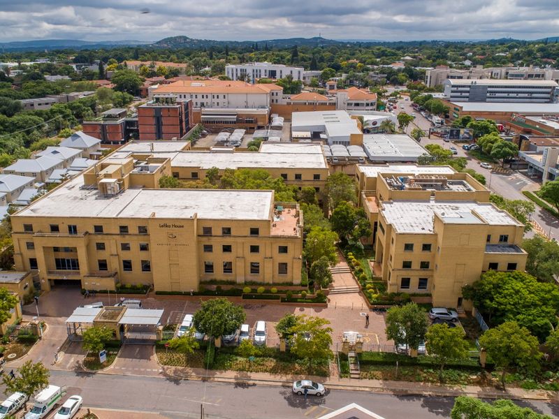 Aerial view of Lefika House, a multi-story commercial office complex featuring brick architecture, dedicated parking facilities, and landscaped grounds in a suburban setting.