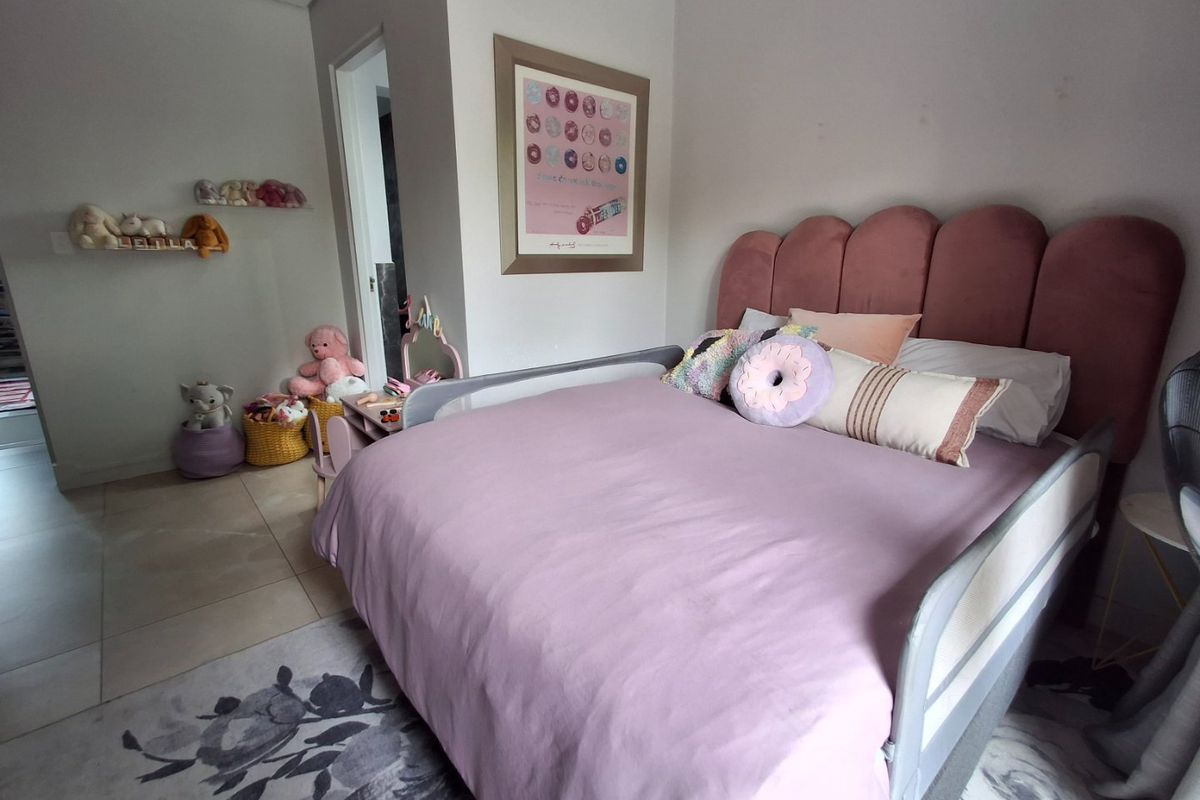 A well-maintained bedroom featuring tiled flooring and a recessed ceiling, currently styled as a child's room.