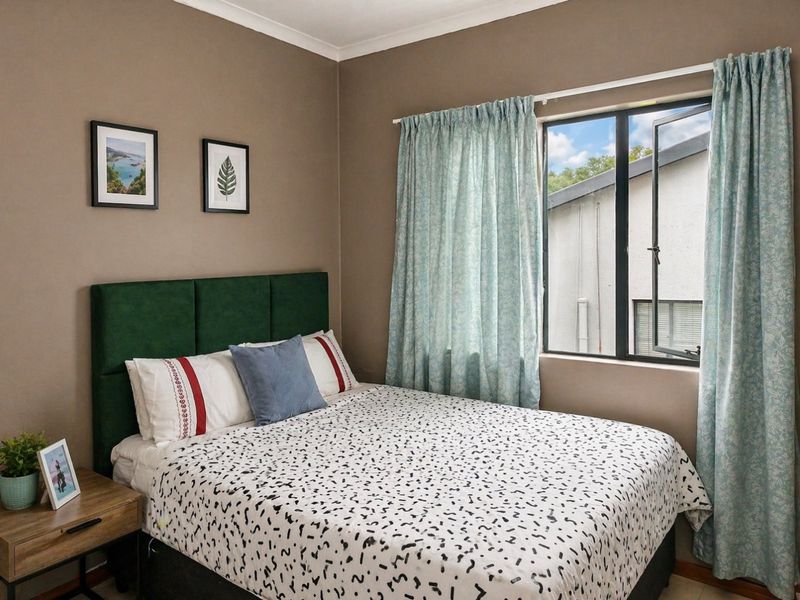 A well-maintained bedroom featuring neutral wall tones, a casement window, and classic coving detail, providing a comfortable and functional living space.
