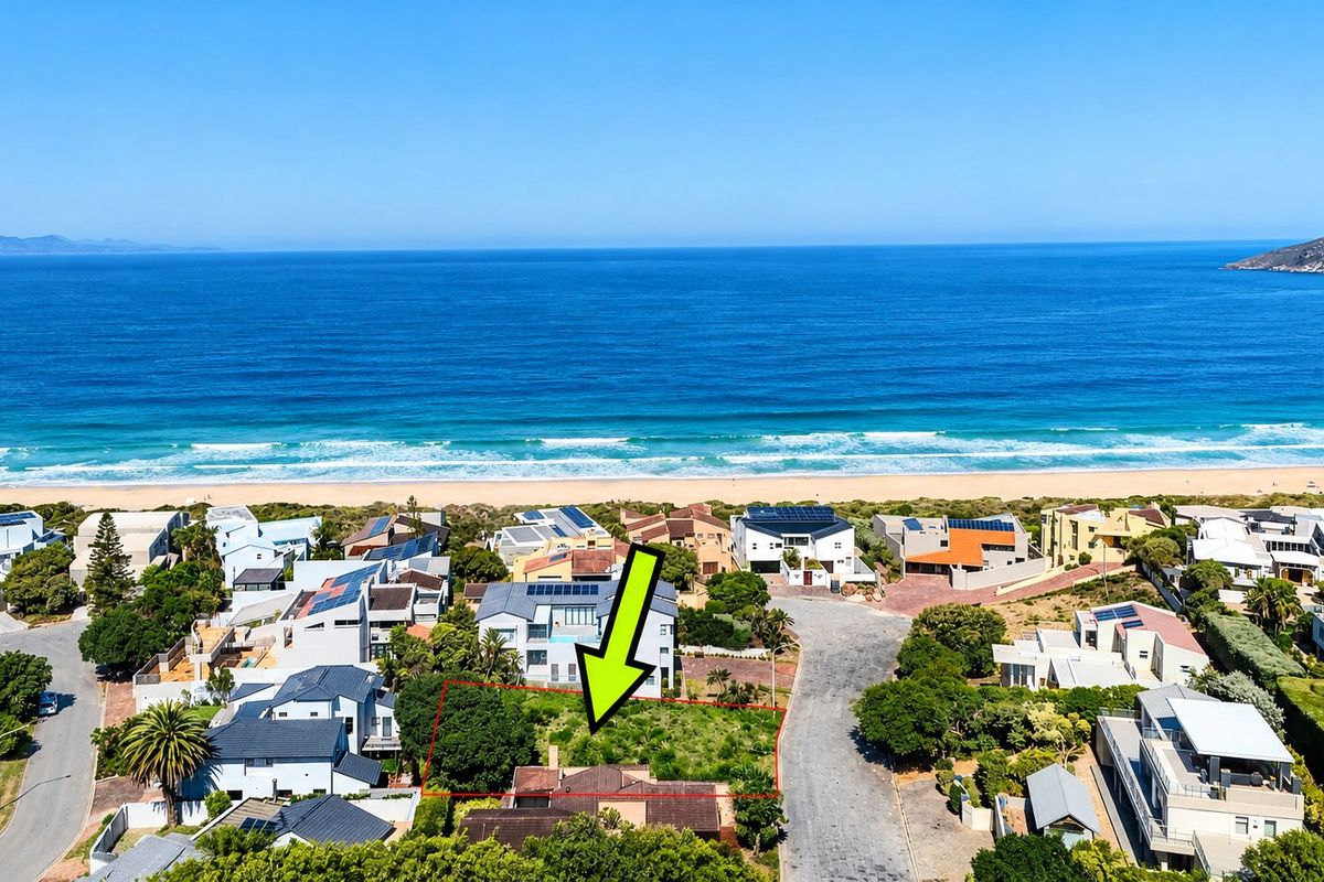 Aerial view of a vacant residential plot situated in a prime coastal location with direct proximity to the beach.