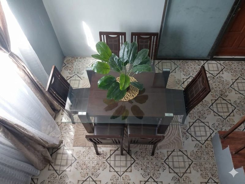 A dining area featuring decorative patterned ceramic floor tiles and a high-angle view of the space.