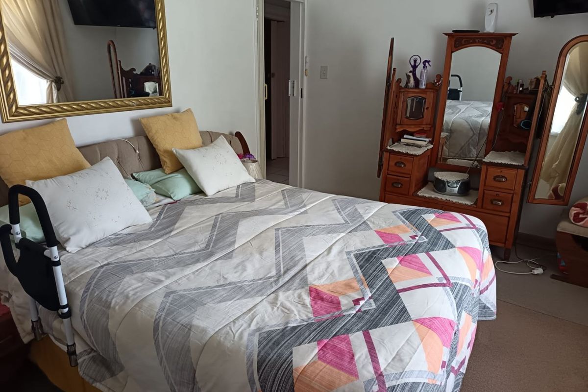 A functional bedroom featuring carpeted flooring and a standard internal doorway, providing a comfortable and private living space.