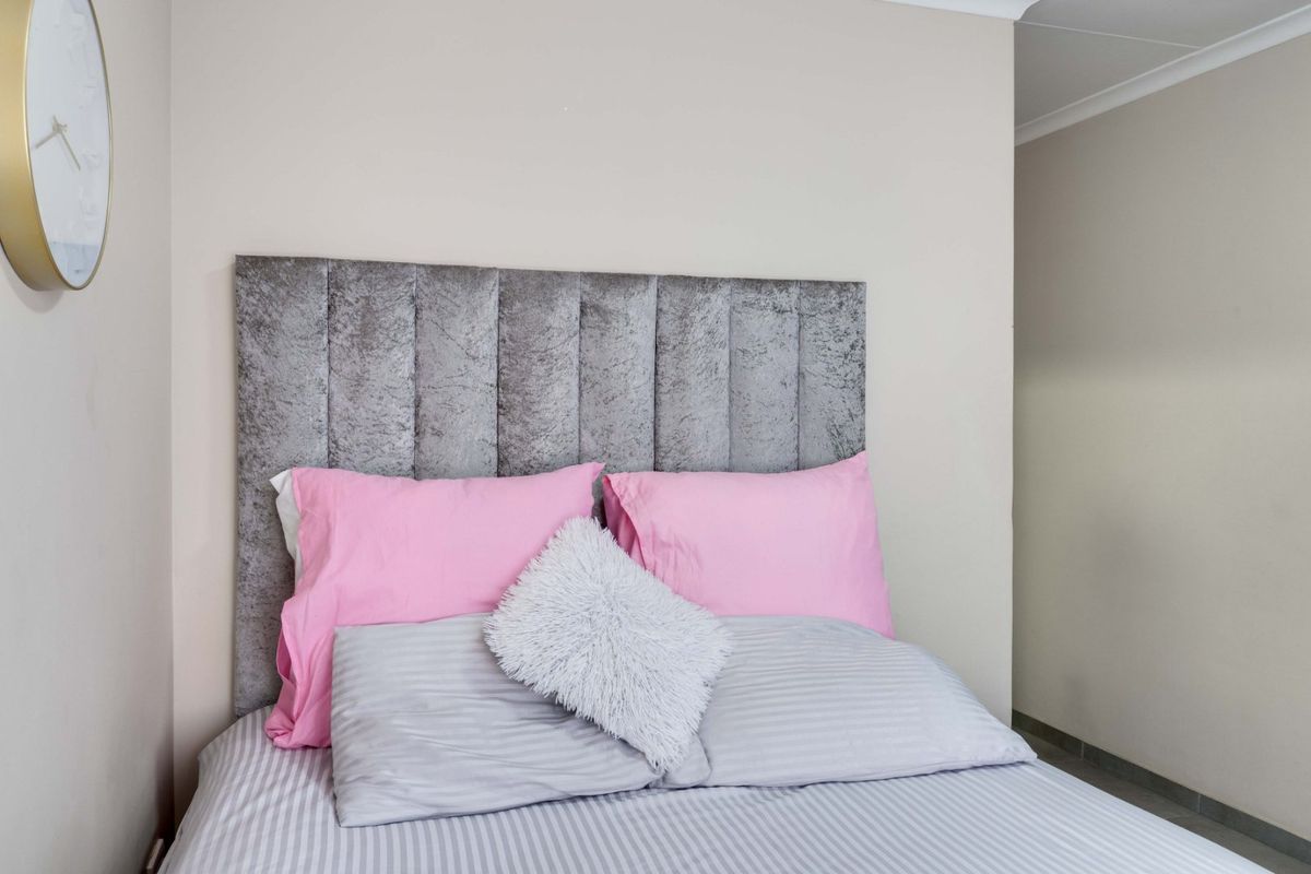 A well-maintained bedroom featuring neutral wall tones and a clean, simple layout.