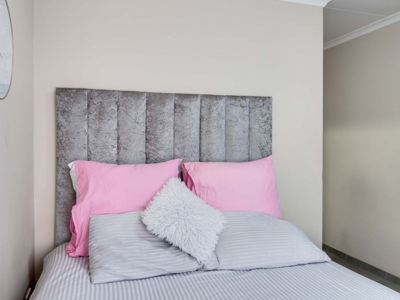A well-maintained bedroom featuring neutral wall tones and a clean, simple layout.
