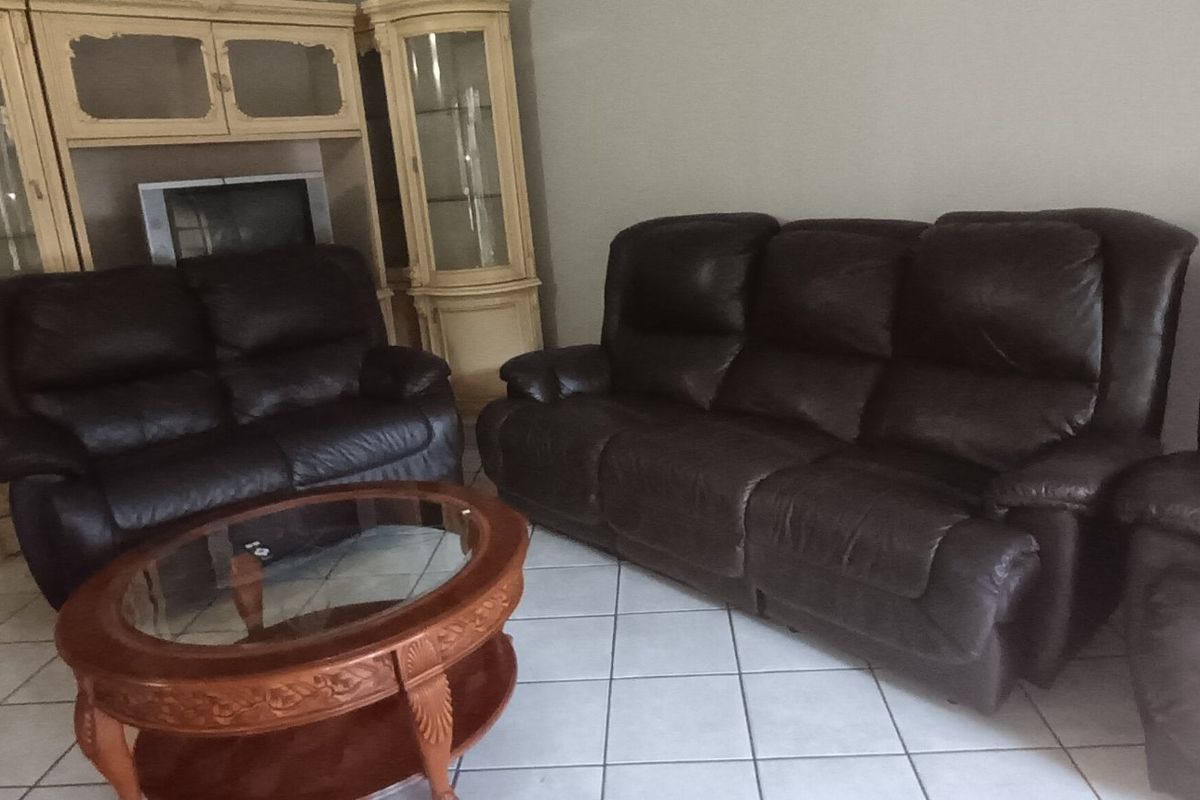 A living room featuring tiled flooring and neutral wall finishes, providing a functional space for relaxation.