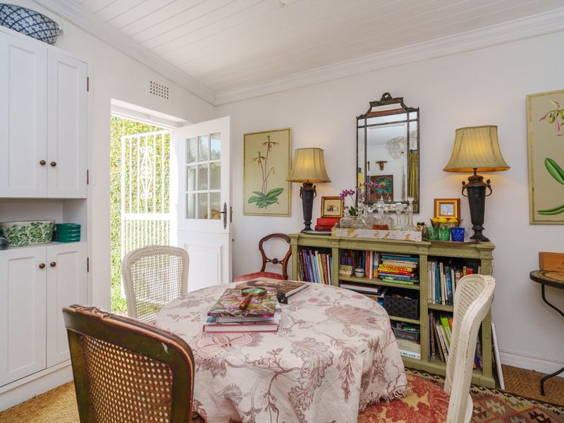A cozy living area featuring built-in cabinetry, a tongue and groove ceiling, and a french door providing direct access to the outdoor space.
