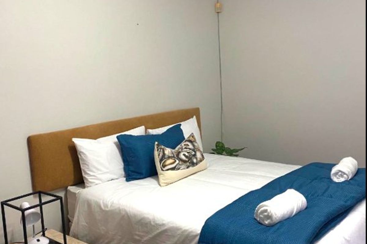 A bedroom featuring parquet flooring and coved ceilings, providing a neutral foundation for personal styling.