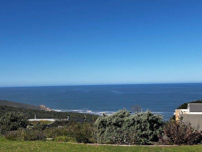 A scenic elevated view overlooking the coastline and ocean, showcasing the natural landscape and horizon.