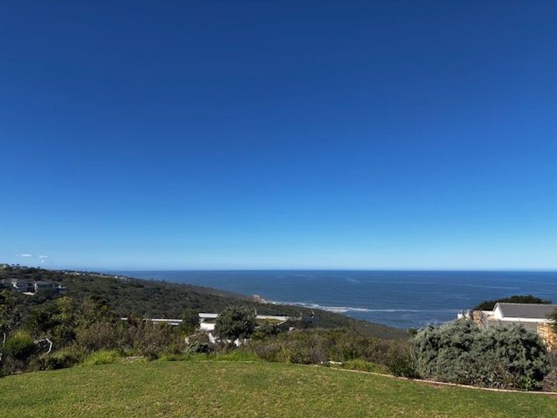 A scenic elevated view overlooking the coastline, ocean, and surrounding natural landscape from the property.