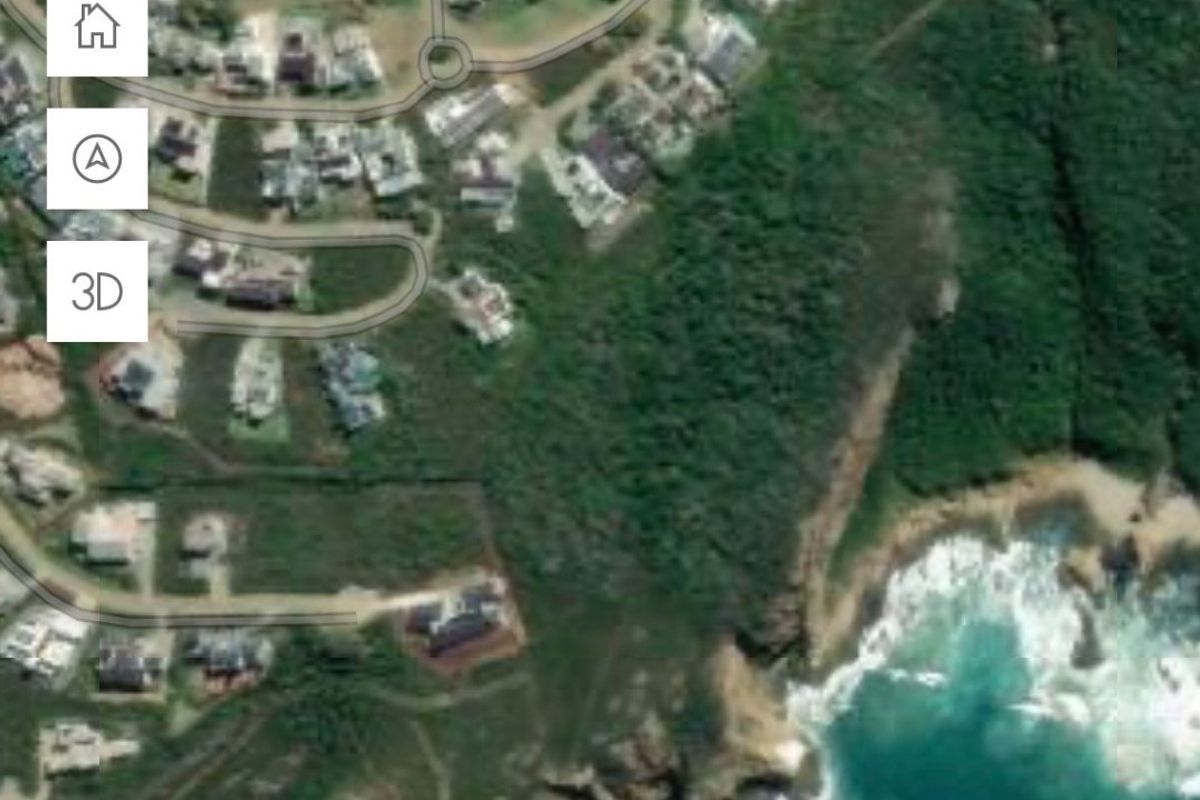 Aerial view of a residential land plot located within a coastal estate, showing proximity to the coastline and surrounding neighborhood infrastructure.