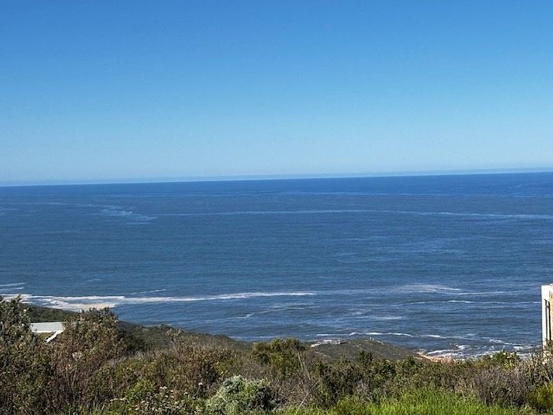 A scenic elevated view overlooking the ocean and coastal landscape, showcasing the natural surroundings of the property.