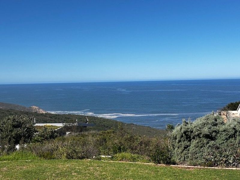 A scenic elevated view overlooking the coastline and ocean, showcasing the natural landscape of the property.