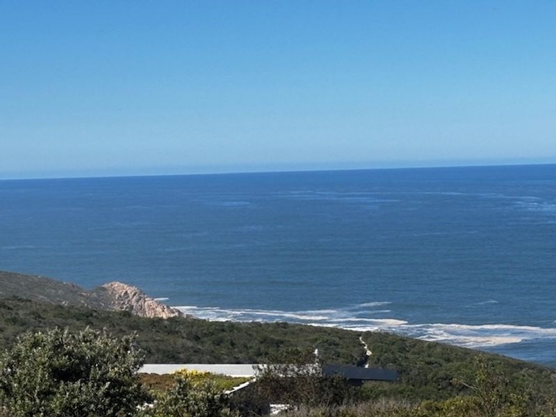 A scenic elevated view overlooking the coastline and ocean, showcasing the natural landscape and horizon.