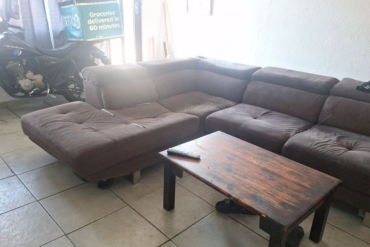 A living room area featuring tiled flooring, providing a functional space for relaxation.