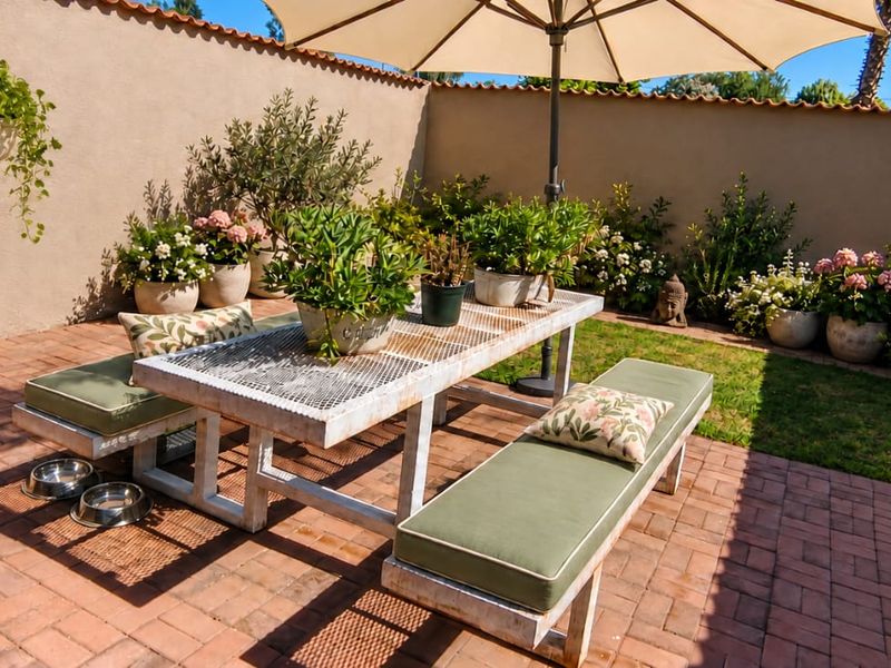 A private, enclosed courtyard featuring brick paving and a high perimeter wall, providing a secluded outdoor space for relaxation.
