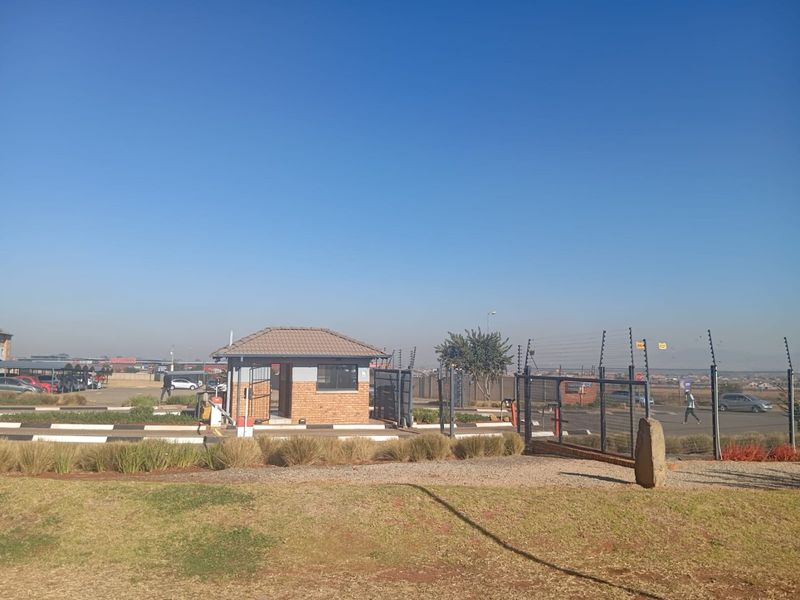 The property entrance features a secure guard house, controlled access gate, and perimeter electric fencing, ensuring a safe and well-managed arrival experience.