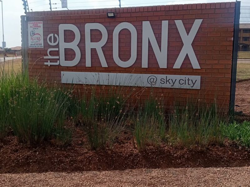 Entrance signage for The Bronx at Sky City, featuring a brick boundary wall with integrated electric fencing.