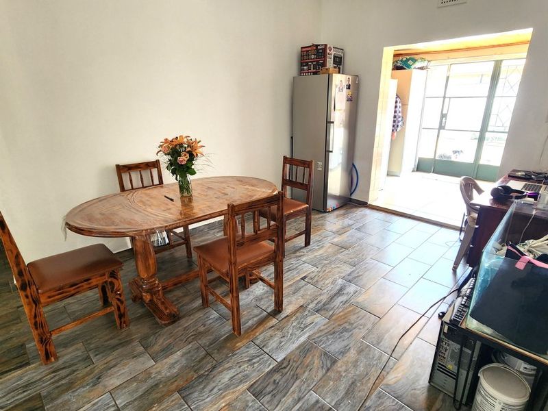 Dining area featuring tiled flooring and direct access to an outdoor space through a sliding door.