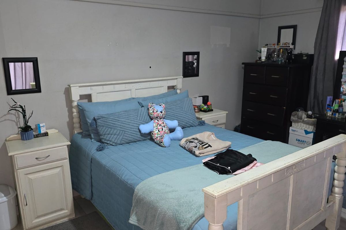A functional bedroom featuring a neutral wall finish and standard bedroom layout, suitable for personalization.