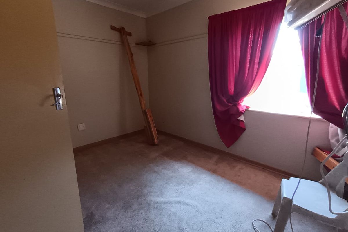 A vacant bedroom featuring carpet flooring and a picture rail, requiring cosmetic updates to improve its overall appeal.