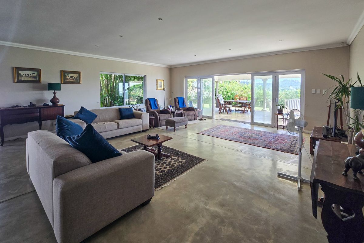 Spacious living room featuring polished concrete floors and large sliding glass doors that provide seamless access to the outdoor patio area.