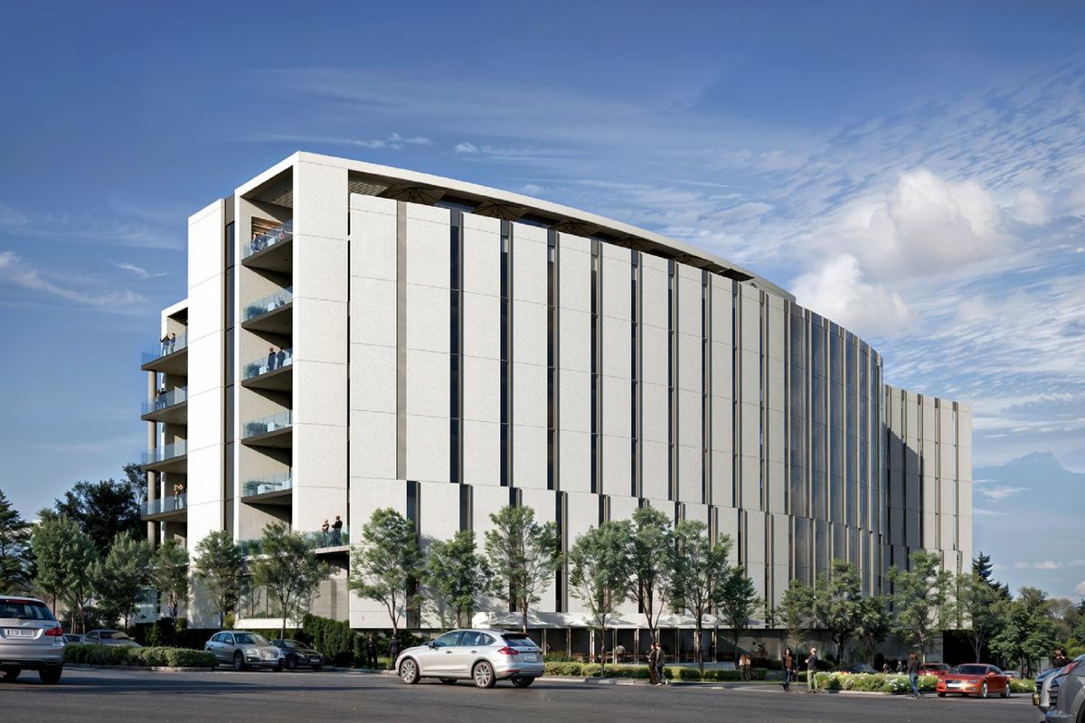 A modern commercial building featuring a sleek facade with vertical paneling, integrated balconies with glass balustrades, and professional landscaping.