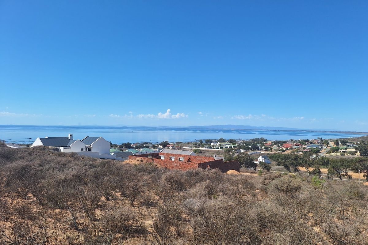 A scenic elevated view overlooking the coastal landscape and ocean, showcasing the surrounding residential area and natural terrain.