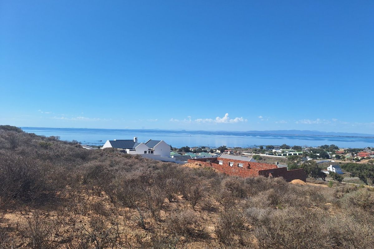 A scenic elevated view overlooking the coastline, ocean, and surrounding residential neighborhood.