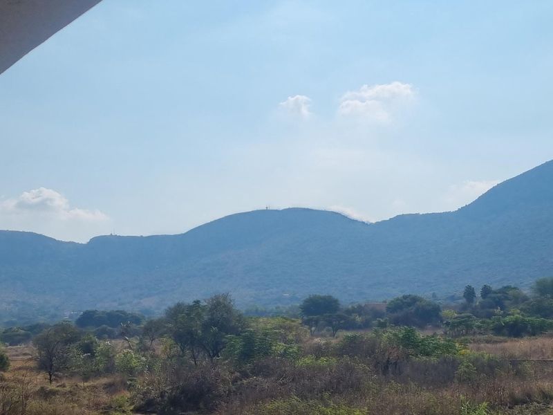 A scenic view of the surrounding mountains and natural landscape as seen from the property.