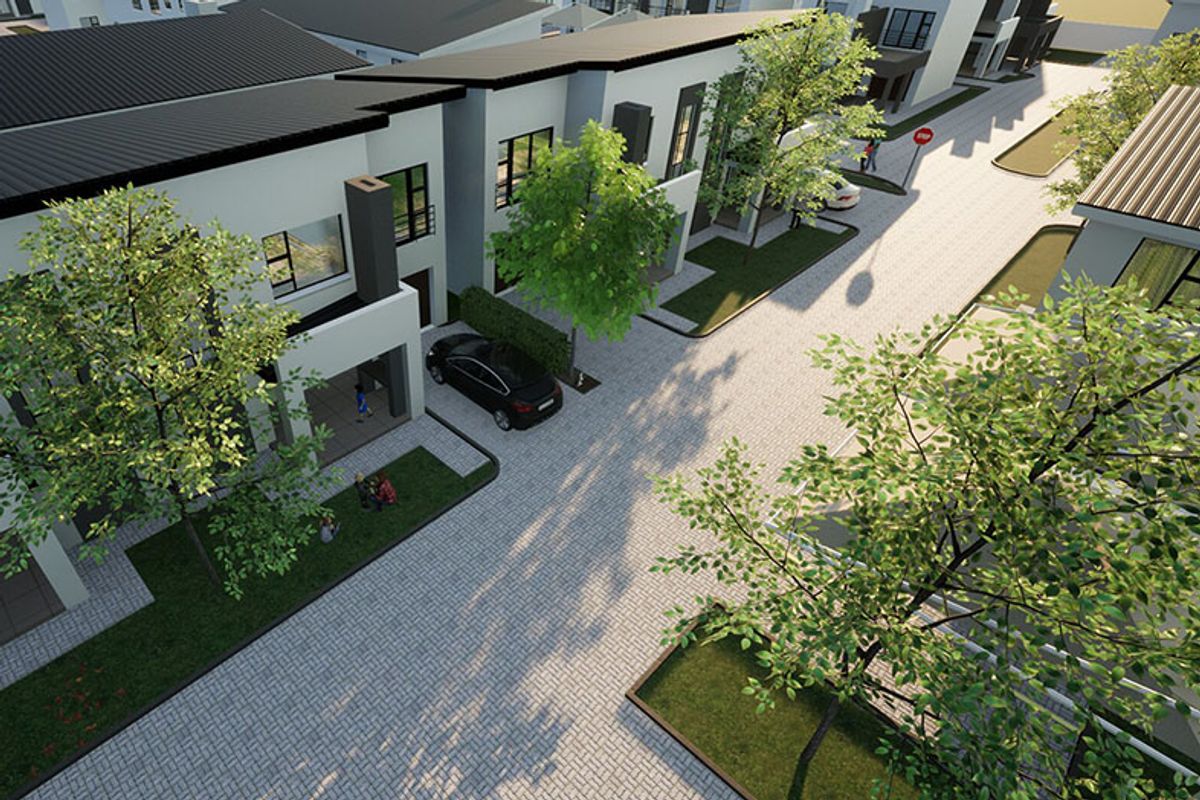 An aerial view of a modern residential estate featuring paved driveways, landscaped gardens, and contemporary architectural facades.