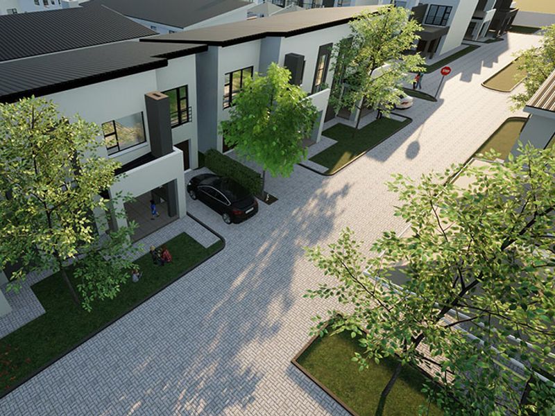 An aerial view of a modern residential estate featuring paved driveways, landscaped gardens, and contemporary architectural facades.