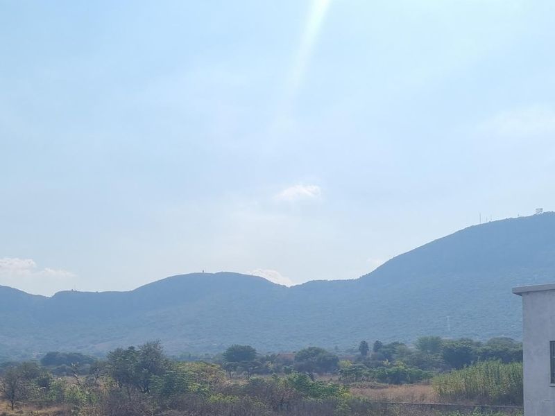 A scenic view of the surrounding landscape and mountains, captured from the property.