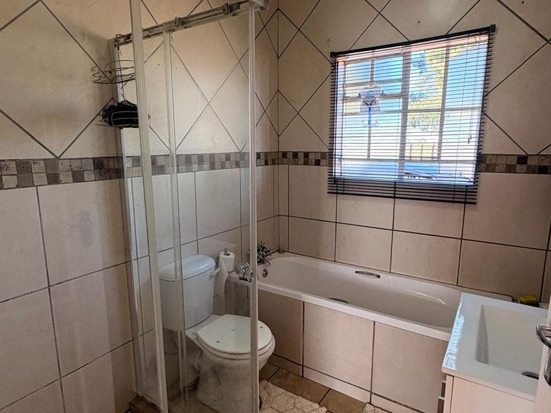 Low-maintenance 2-bedroom facebrick home with a built-in braai, modern finishes, prepaid electricity, and excellent security in Stilfontein Extension 4. - Photo 10