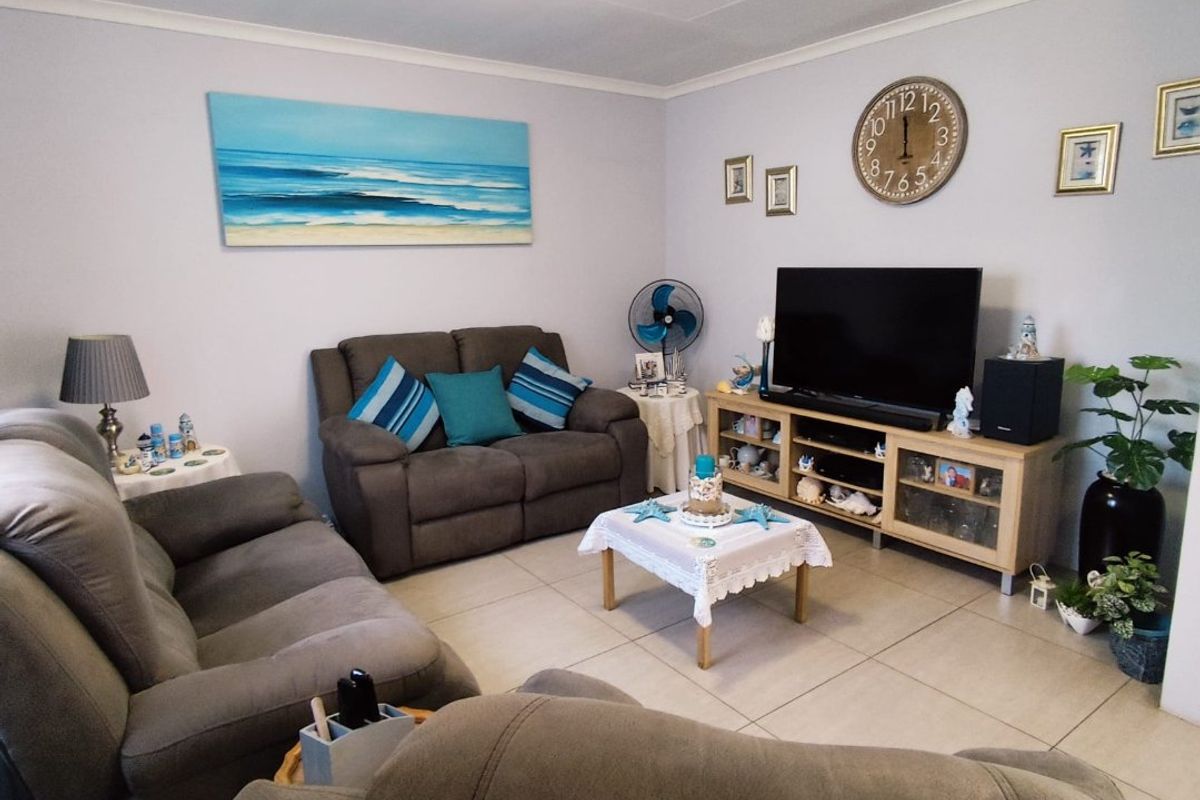 A comfortable living room featuring neutral floor tiles and a clean, well-maintained interior space suitable for relaxation.