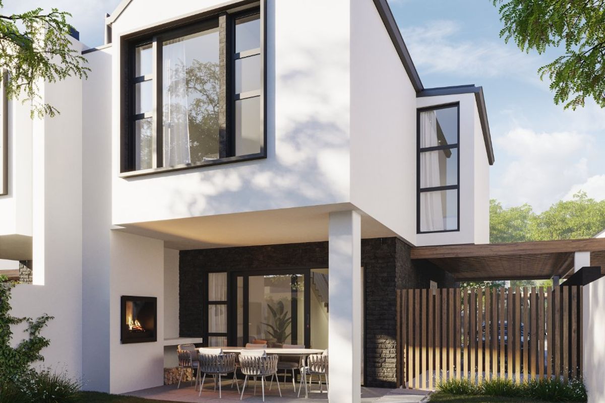 Modern rear exterior view featuring a covered patio with a built-in fireplace, stone accents, and timber fencing overlooking a landscaped garden.