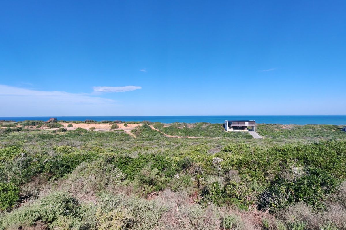 A panoramic view of the coastal landscape and ocean, showcasing the natural surroundings of the vacant residential land.