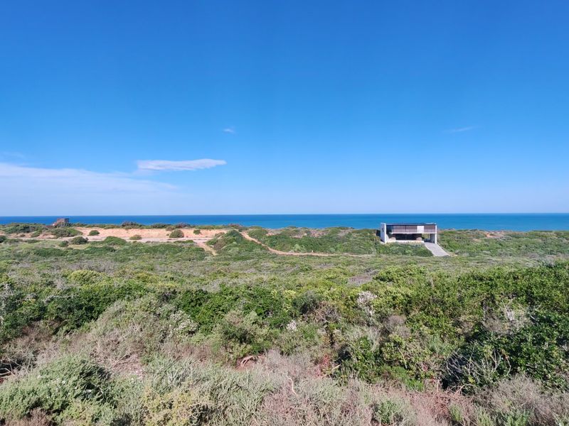 A panoramic view of the coastal landscape and ocean, showcasing the natural surroundings of the vacant residential land.