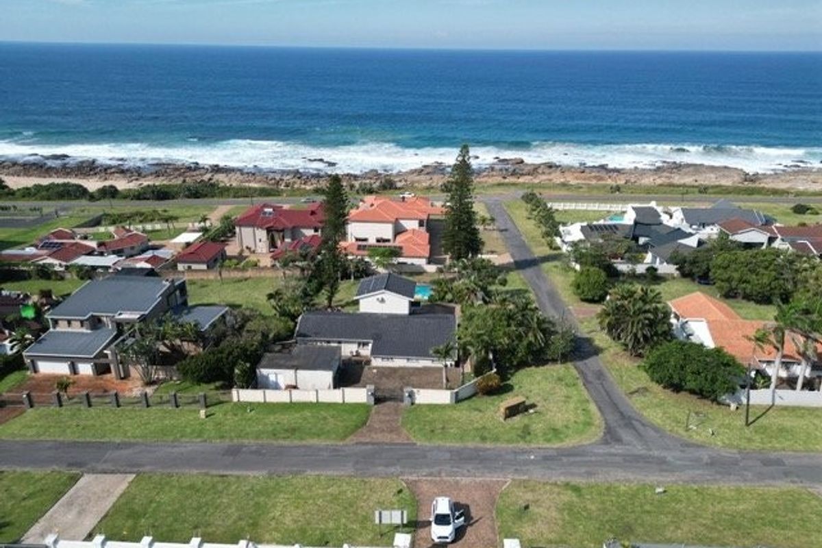 Aerial view of a coastal residential neighborhood, showcasing proximity to the ocean and surrounding properties.