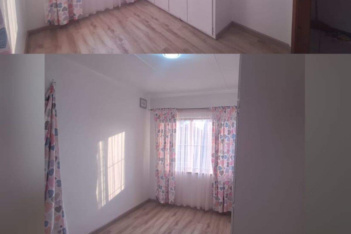 A bright, empty bedroom featuring laminate flooring and built-in cupboards, offering a clean and neutral space ready for personalization.