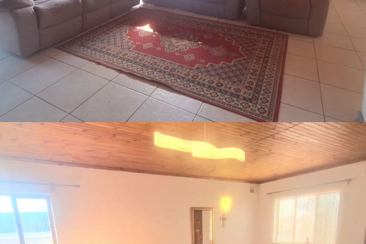 Spacious living room featuring a timber-clad ceiling, tiled flooring, and a timber balustrade, offering a warm and functional living space.
