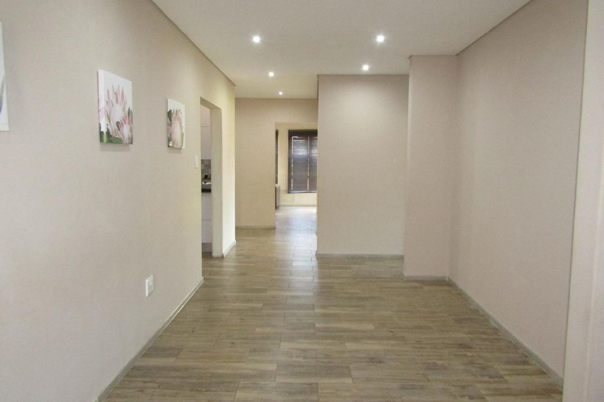 This property is just as lovely as the outside. As soon as you walk in the front door, you’re greeted by a warm and welcoming atmosphere. The house is spacious and has big aluminium windows that let in lots of natural light. - Photo 4