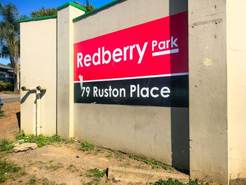 A view of the boundary wall and signage for Redberry Park at 79 Ruston Place.
