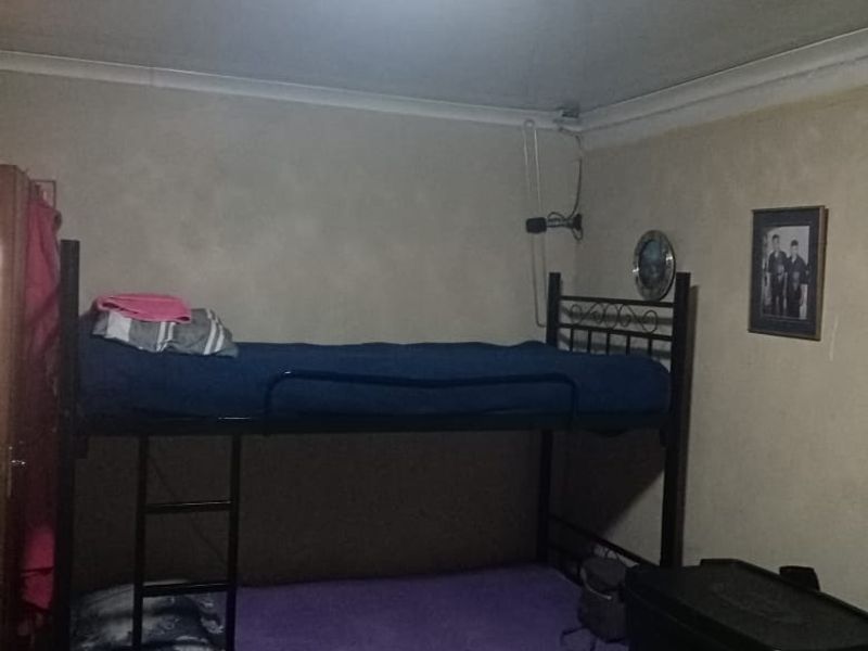 A bedroom featuring basic finishes, coving, and a central ceiling light fixture.