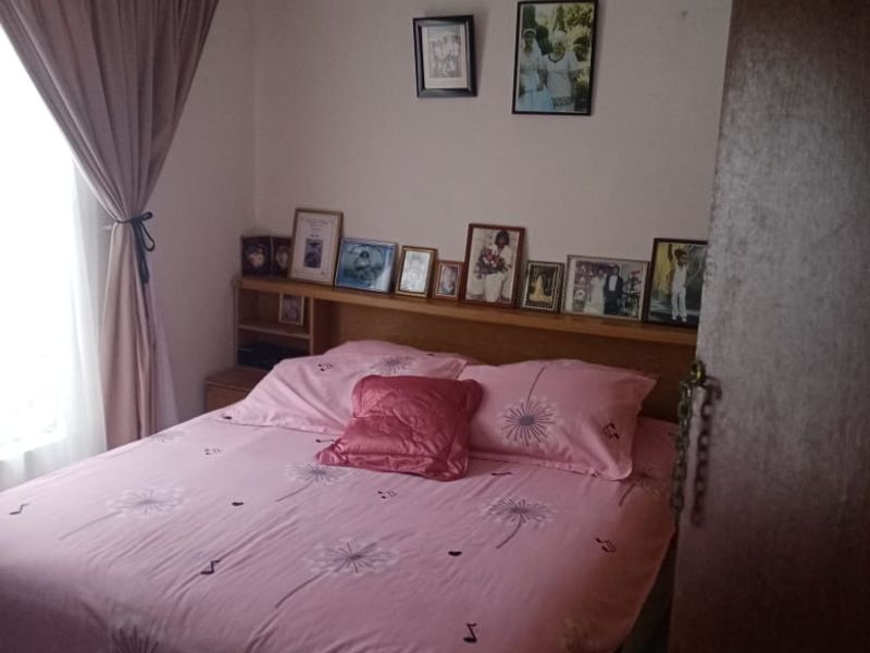 A standard bedroom featuring tiled flooring and a built-in wooden headboard.