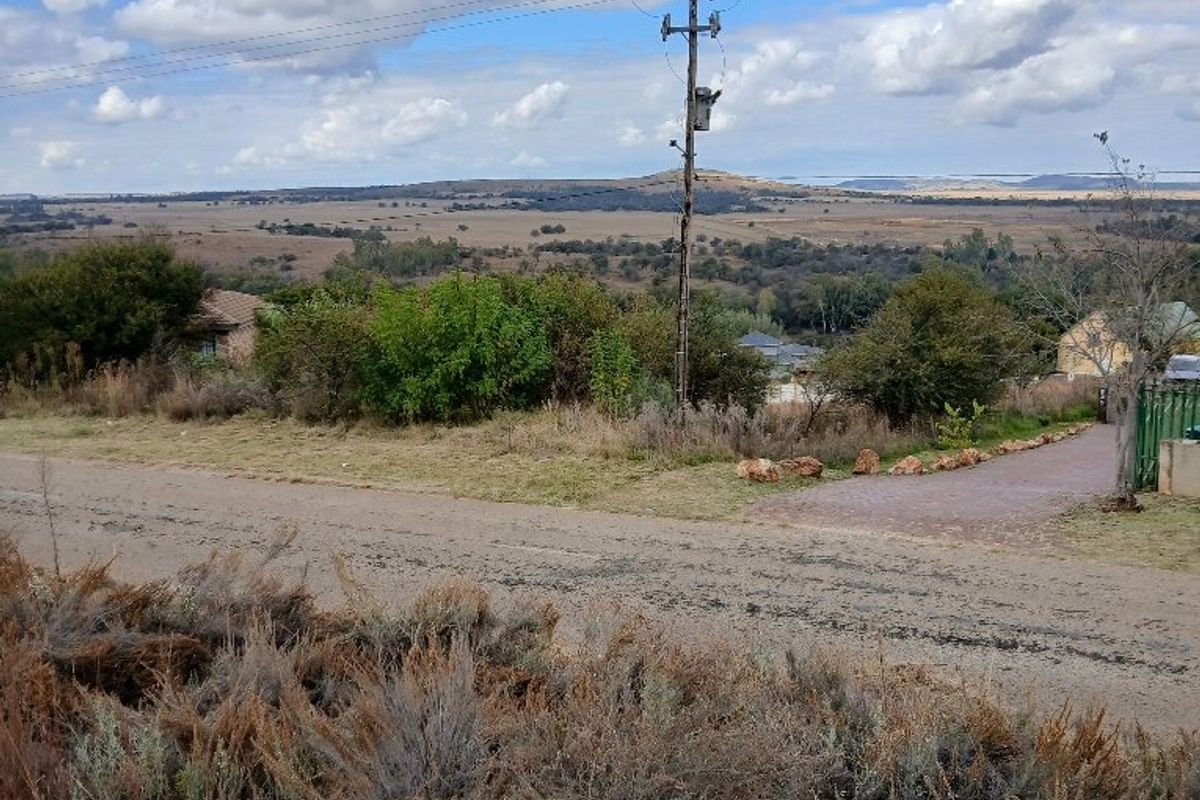 A wide-angle view of the surrounding landscape and rural terrain, featuring an existing utility pole and overhead power lines.